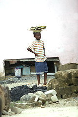 Image showing Portrait of an african boy wearing bananas on his head
