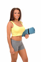Image showing Teen girl with yoga matt.