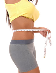 Image showing Teenager girl measuring tummy.