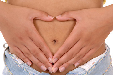 Image showing Woman holding hands on stomach.