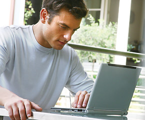 Image showing man is working on laptop computer