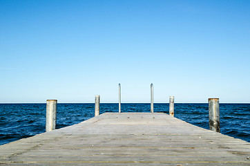 Image showing Low angle image of a wooden bath pier in blue water