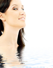 Image showing smiling brunette with diamond make-up in water