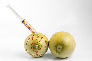 Image showing Melons and syringe with pills