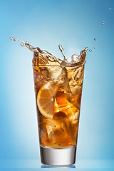 Image showing Glass of splashing iced tea with lemon