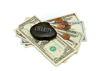 Image showing charity stone with money over white