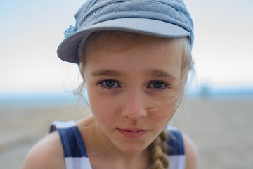 Image showing Cute girl is looking with serious face at camera