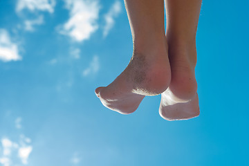 Image showing Children's feet against the blue sky