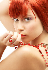 Image showing redhead with red beads looking over shoulder