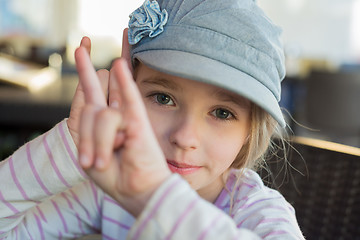 Image showing Cute girl showing horn signs