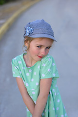 Image showing Blonde young kid in denim cap  and dress