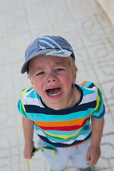 Image showing Crying boy standing on the street