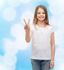 Image showing little girl in white t-shirt showing peace gesture