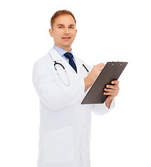 Image showing smiling male doctor with clipboard and stethoscope