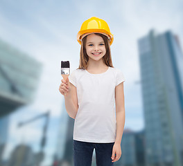 Image showing smiling little girl in helmet with paint roller