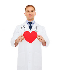 Image showing smiling male doctor with red heart