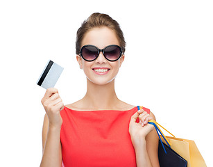 Image showing smiling woman with shopping bags and plastic card