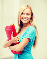 Image showing smiling student with folders