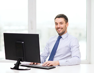 Image showing smiling businessman or student with computer