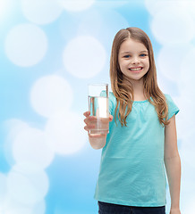 Image showing smiling little girl giving glass of water