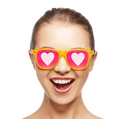 Image showing happy teenage girl in shades with hearts