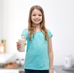 Image showing smiling little girl giving glass of milk