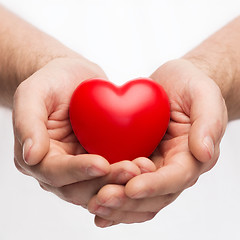 Image showing male hands with small red heart