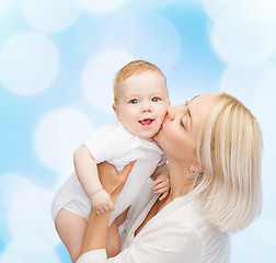 Image showing happy mother kissing smiling baby