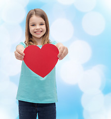 Image showing smiling little girl giving red heart