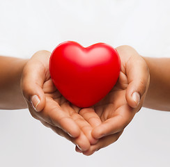 Image showing female hands with small red heart