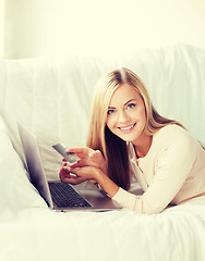 Image showing businesswoman with laptop and credit card