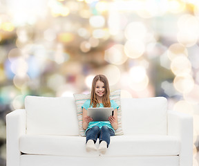 Image showing little girl sitting on sofa with tablet pc