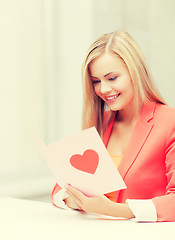 Image showing woman holding postcard with heart shape