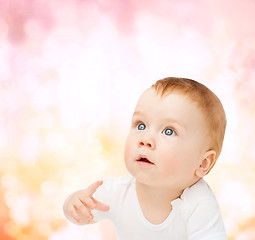 Image showing curious baby looking up