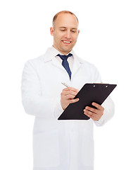 Image showing smiling male doctor with clipboard and pen