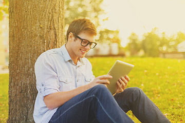 Image showing smiling male student in eyeglasses with tablet pc