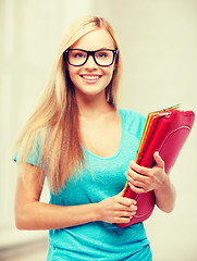 Image showing smiling student with folders