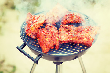 Image showing close up of meat on grill outdoors