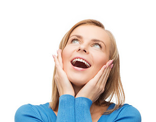 Image showing amazed laughing young woman