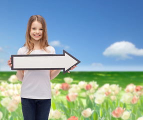 Image showing smiling girl with blank arrow pointing right