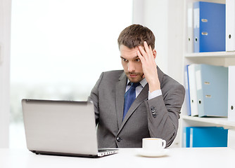 Image showing busy businessman with laptop and coffee