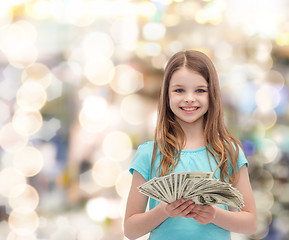 Image showing smiling little girl with dollar cash money