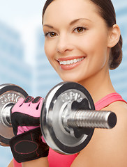 Image showing asian sporty woman with heavy dumbbell