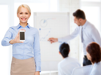 Image showing smiling businesswoman with smartphone blank screen