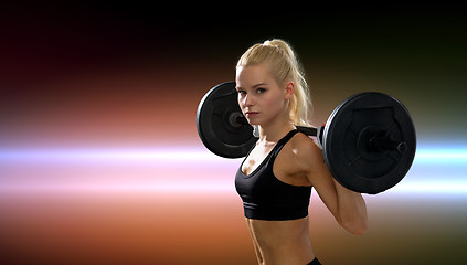 Image showing sporty woman exercising with barbell