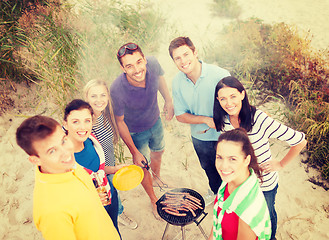 Image showing group of friends making barbecue on the beach