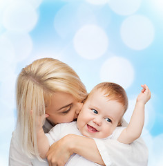 Image showing happy mother kissing smiling baby