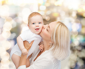 Image showing happy mother kissing smiling baby