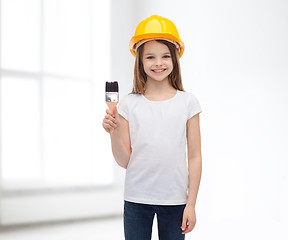 Image showing smiling little girl in helmet with paint roller