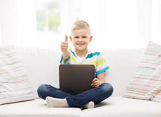 Image showing smiling boy with tablet computer at home